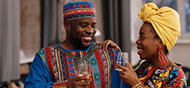 An African couple with a glass of wine on a date.
